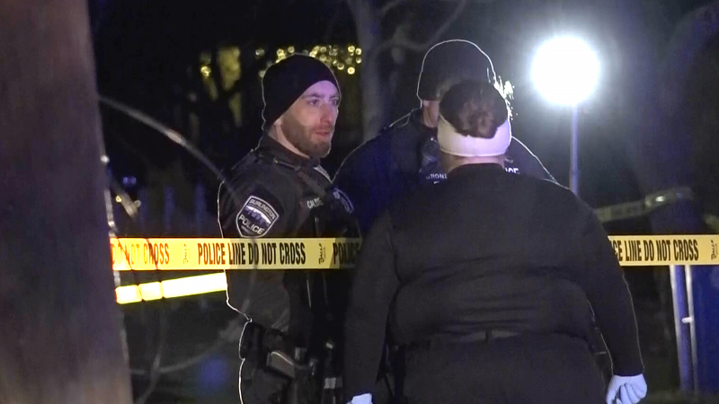 Law enforcement officers speak near police tape at a scene where three men were shot and injured in Burlington, Vermont, U.S., November 25, 2023. /CFP