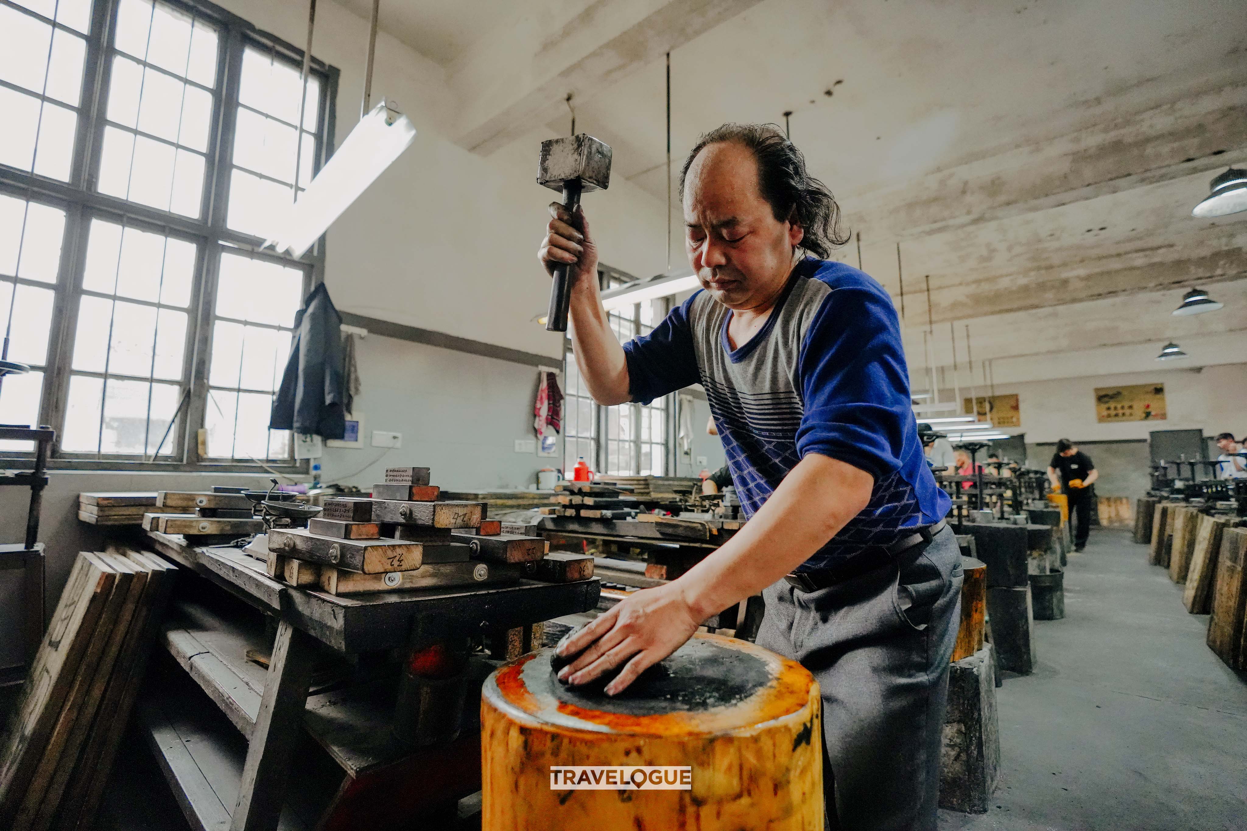 An undated photo shows artisans making Hui ink at a workshop in east China's Anhui Province. /CGTN