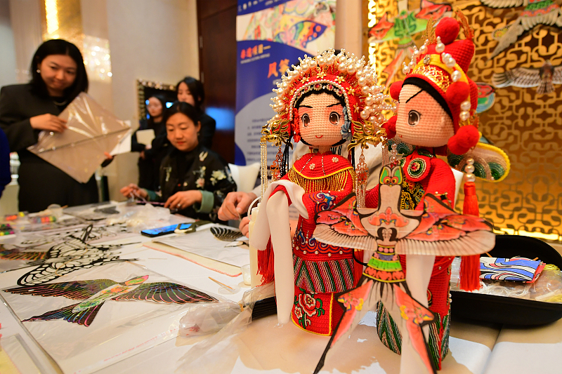 A pair of traditional Chinese style figurines are on display at a cultural event in Beijing, November 27, 2023. /CFP