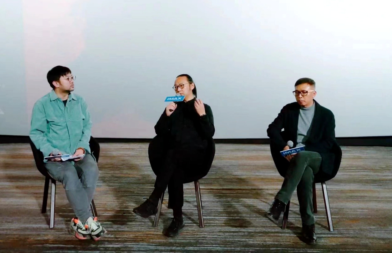 Sound Director Wang Gang (center) speaks at a press event held in Beijing on November 25, 2023, the day 