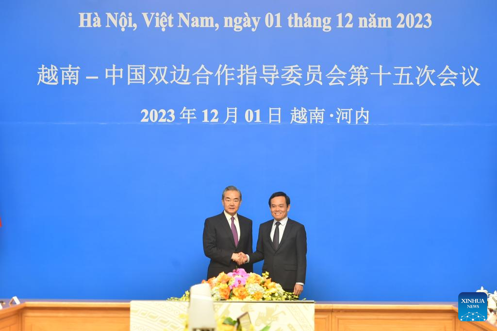 Chinese Foreign Minister Wang Yi (L), also a member of the Political Bureau of the Communist Party of China (CPC) Central Committee and director of the Office of the Foreign Affairs Commission of the CPC Central Committee, and Vietnamese Deputy Prime Minister Tran Luu Quang, co-chair the 15th meeting of the China-Vietnam Steering Committee for Bilateral Cooperation in Hanoi, Vietnam, December 1, 2023. /Xinhua