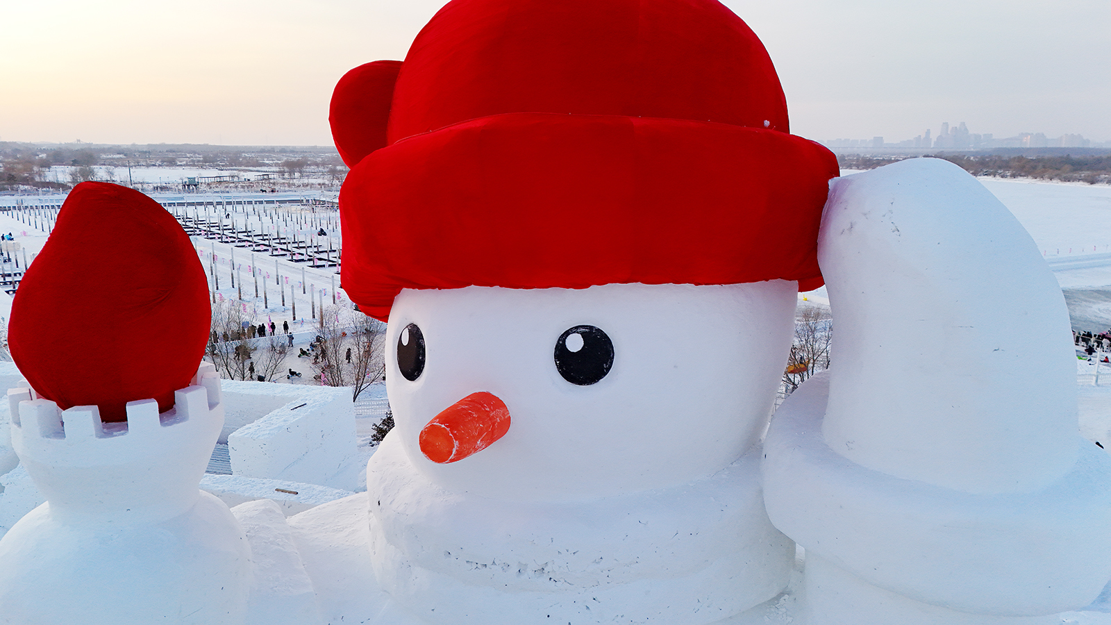 Wearing a red hat and holding a torch, a huge snowman gets ready to welcome visitors to Harbin, Heilongjiang Province, in this photo taken on December 3, 2023. /IC