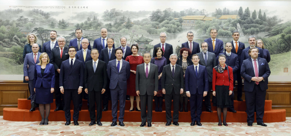 Member of the Political Bureau of the CPC Central Committee and Chinese Foreign Minister Wang Yi takes a group photo with envoys and diplomats of the EU and its member states in Beijing, China, December 4, 2023. /Chinese Foreign Ministry