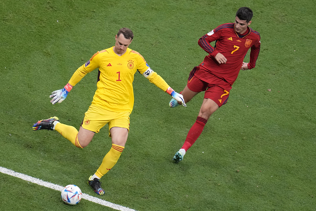 Germany's goalkeeper Manuel Neuer, left, kicks the ball ahead of Spain's Alvaro Morata during their World Cup group E match at the Al Bayt Stadium in Al Khor, Qatar, on Sunday, November 27, 2022. /CFP