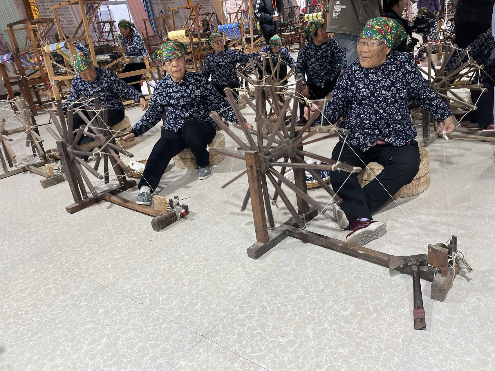 Women spin cotton to be made into fabric at a cloth company in Yongji, Shanxi on November 16, 2023. /CGTN