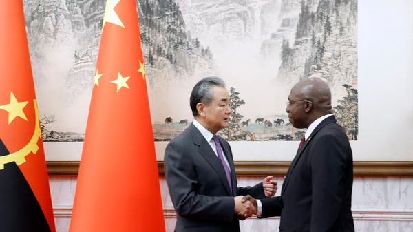 Chinese Foreign Minister Wang Yi (L), also a member of the Political Bureau of the Communist Party of China Central Committee, shakes hands with Angolan Foreign Minister Téte António in Beijing, China, December 6, 2023. /Chinese Foreign Ministry