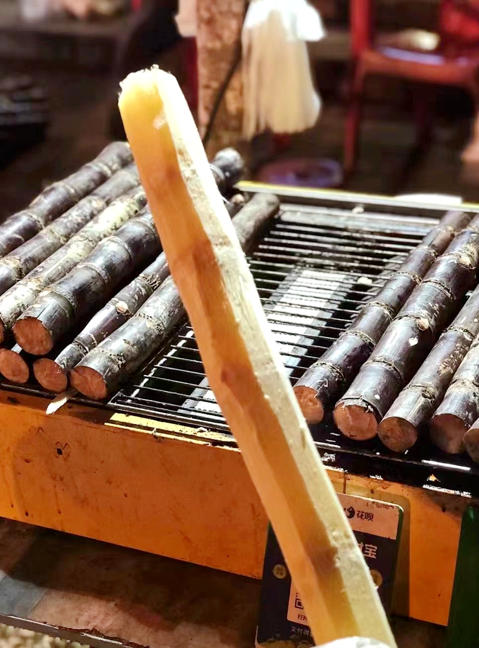 Grilled sugarcane is a popular snack in Hainan Province. /Photo provided to CGTN