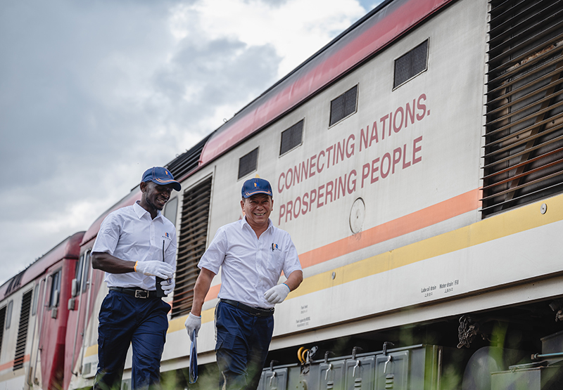 A Chinese train driver (R) and a Kenyan worker walk by a locomotive at the  Chinese-built Mombasa-Nairobi Standard Gauge Railway in Nairobi, Kenya, May 23, 2023. /Xinhua