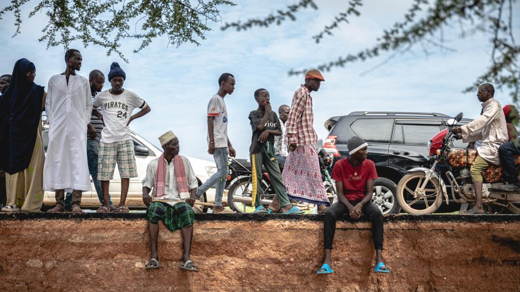 People are at a section of a road that collapsed due to flash floods at the Bangali-Garissa Road near Garissa, Kenya, December 1, 2023. /Xinhua