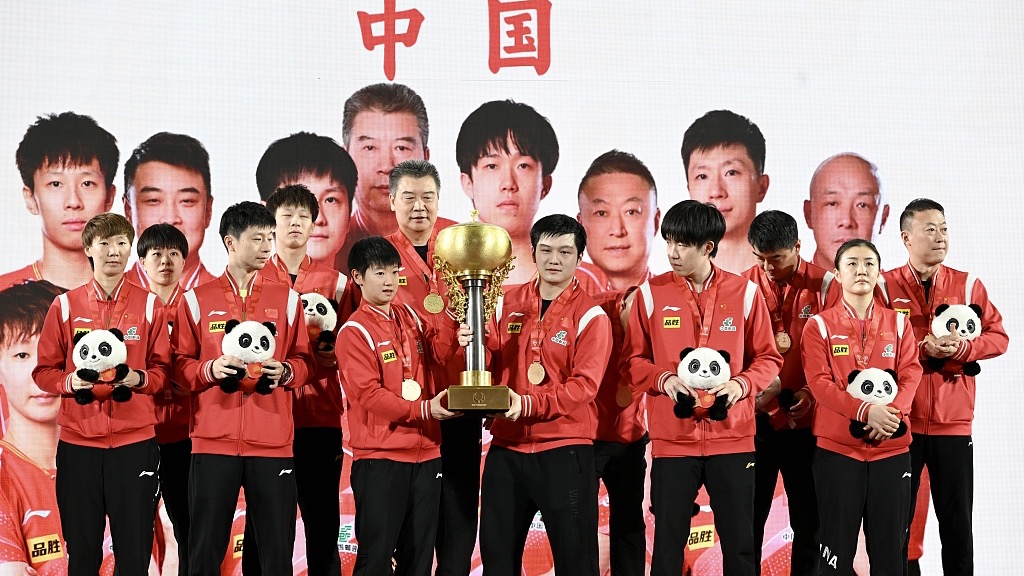 Chinese players celebrate with the Guoliang-Sorling Trophy after their final win at the International Table Tennis Federation Mixed Team World Cup in Chengdu, China, December 10, 2023. /CFP