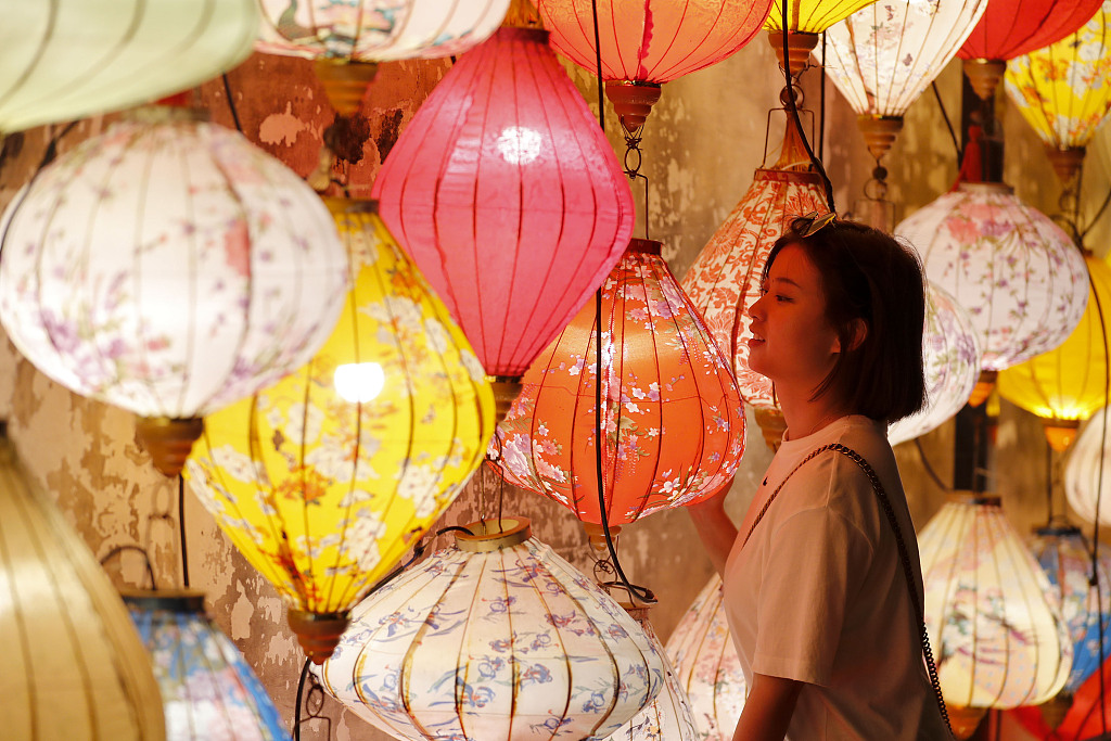 A woman poses for a photo at a Mid-Autumn Festival lantern fair in Huangshan, Anhui Province, China, on September 19, 2021. /CFP