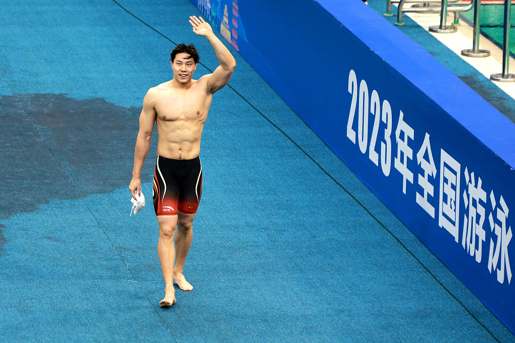 Qin Haiyang of China greets fans after winning the men's 100m breaststroke final during the Chinese National Swimming Championships in Jinan, China, December 10, 2023. /CFP