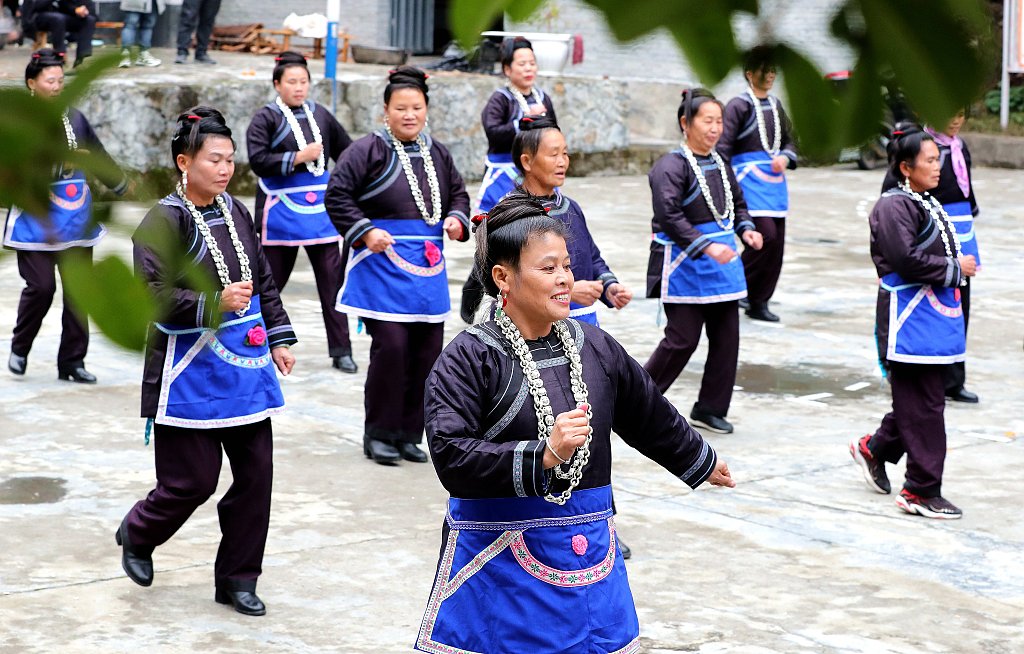 Photo taken on December 12, 2023 shows Dong women dancing in groups to celebrate Dong New Year in Jiuwai Dong Village, Rongjiang County, Guizhou Province. /CFP