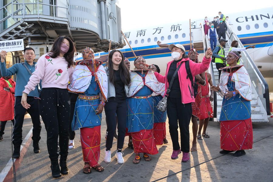 Chinese tourists interact with Maasai performers at Jomo Kenyatta International Airport in Nairobi, Kenya, Febuary 11, 2023. /Xinhua