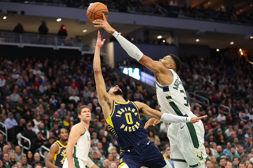 Giannis Antetokounmpo (R) of the Milwaukee Bucks blocks a shot by Tyrese Haliburton of the Indiana Pacers in the game at Fiserv Forum in Milwaukee, Wisconsin, December 13, 2023. /CFP