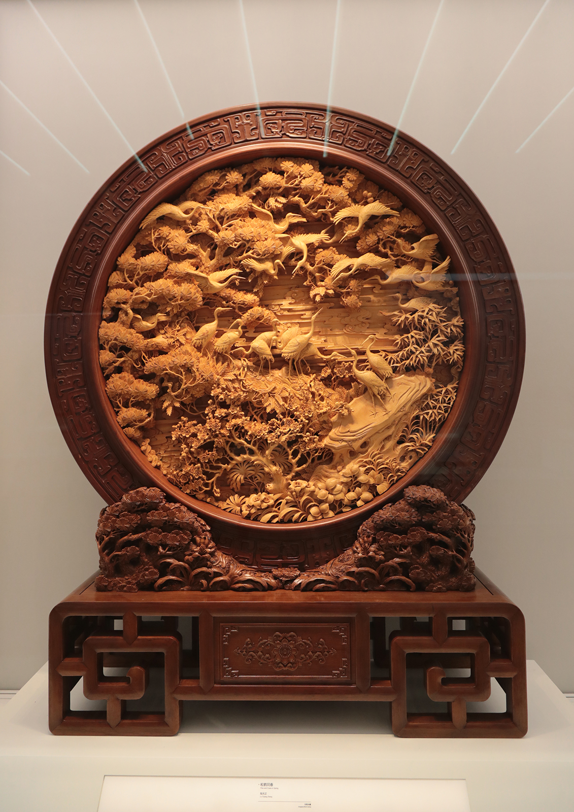 A wood carving work featuring pines and cranes is on display at Zhejiang Intangible Cultural Heritage Museum in Hangzhou, Zhejiang Province. /CGTN