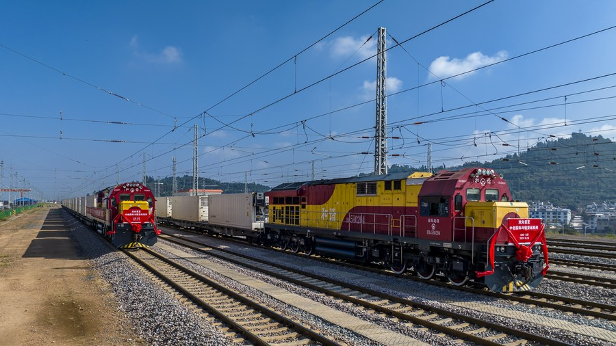A China-Vietnam (L) and a China-Laos international cold-chain freight trains pulling out of Yanhe Station of Yuxi City, southwest China's Yunnan Province, October 16, 2023. /Xinhua