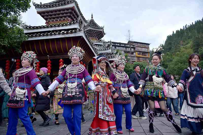 Dong women dressed in beautiful attire dance together to celebrate their New Year in Liping County, Qiandongnan Miao and Dong Autonomous Prefecture, Guizhou Province, December 16, 2023. /CFP