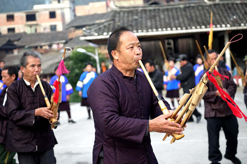Dong people play the lusheng, a traditional musical instrument, to celebrate Dong New Year in Rongjiang County, Qiandongnan Miao and Dong Autonomous Prefecture, Guizhou Province, December 6, 2023. /CFP