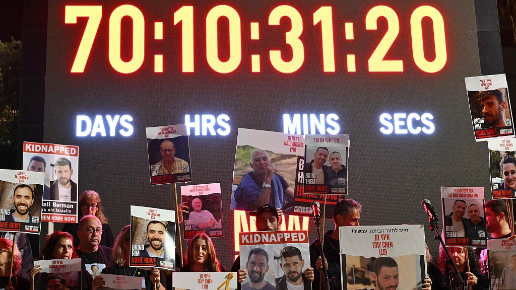 Families of Israeli hostages held in Gaza since the October 7 attack lift placards depicting their relatives ahead of a statement to the media in Tel Aviv, Israel, December 16, 2023. /CFP