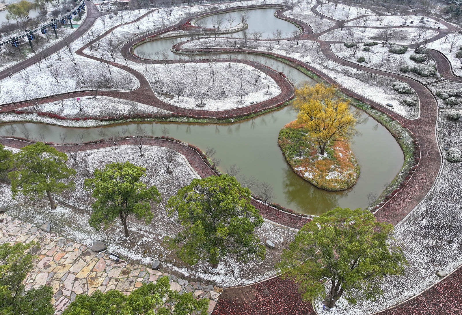 An aerial view of Dream Island, a botanical garden on the Yangtze River in Nantong, Jiangsu Province, is seen on December 16, 2023 after the first snowfall in the area. /IC