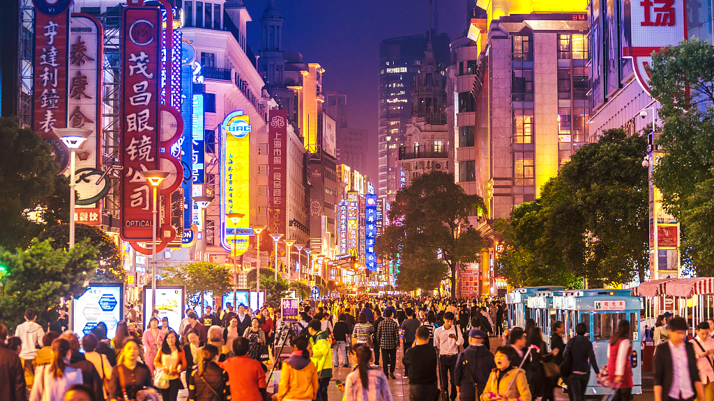 A view of a bustling shopping street at night in Shanghai, China. /CFP
