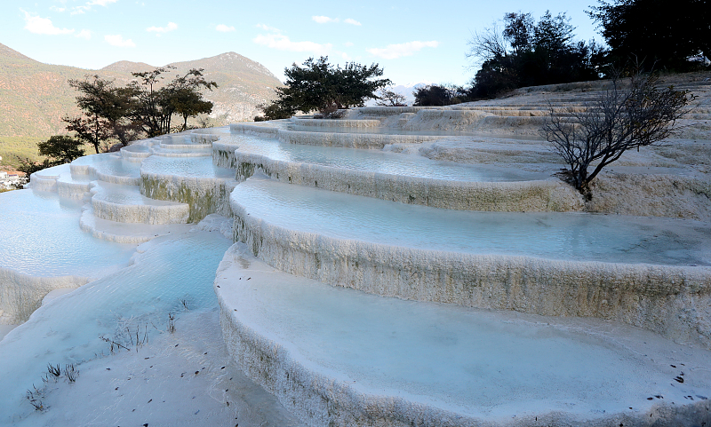 White Water Terrace is a popular tourist spot featuring fairytale views in Yunnan Province, December 16, 2023. /CFP