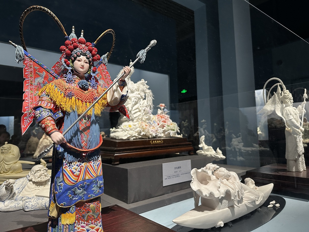 Photo taken on December 17, 2023 shows pieces in various kinds of shapes, including a figurine in Peking Opera costume at a Dehua porcelain exhibition at the National Museum of China in Beijing. /CFP