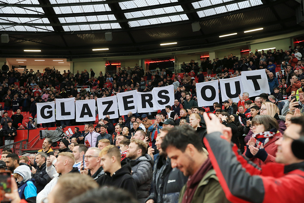 Manchester United fans hold up letters spelling 