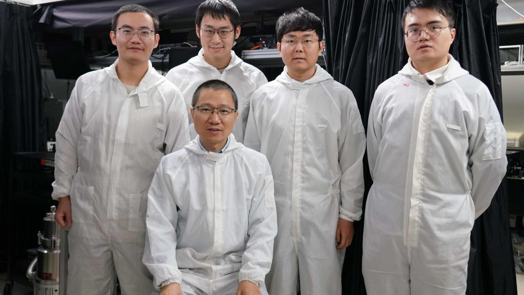 Liu Kaihui (front), director of the Institute of Condensed Matter and Material Physics, School of Physics, Peking University, and other members of a research team pose for a group photo in Peking University, Beijing, capital of China, December 15, 2023. /Xinhua