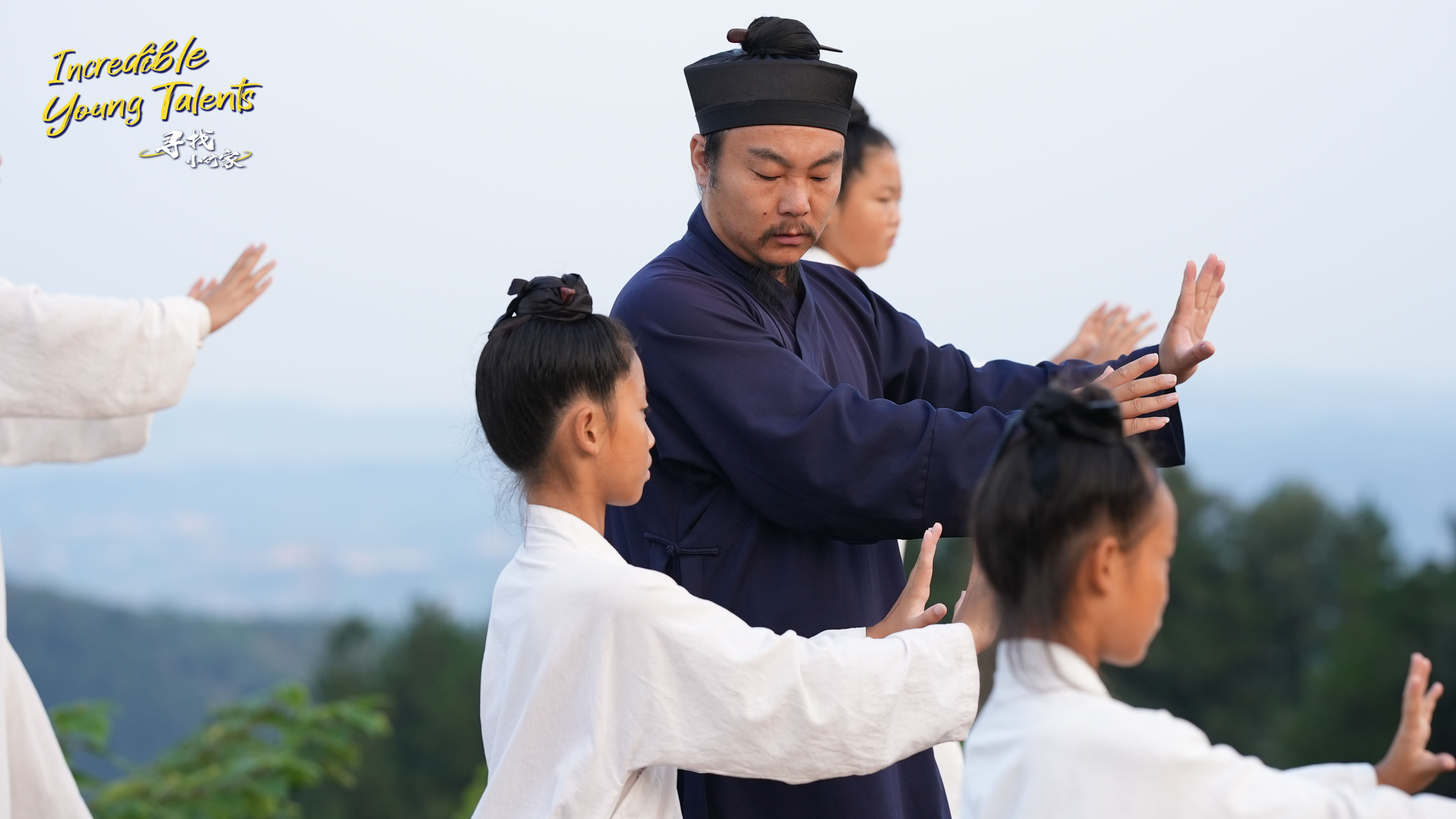 Wudang-style Tai Chi master Hu Weizhe (center) is one of the top masters at the Wudang Xuanmen Martial Arts Academy. The photo shows him teaching young apprentices basic routines. /CGTN