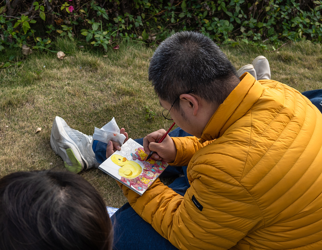 A tourist draws the public artwork 