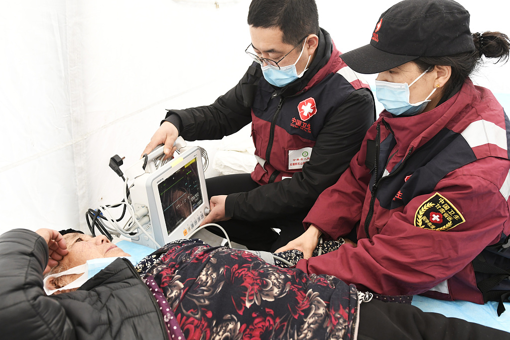 Medical workers examine a resident in Dahejia Township, Jishishan County, northwest China's Gansu Province on Dec. 22, 2023. /CFP