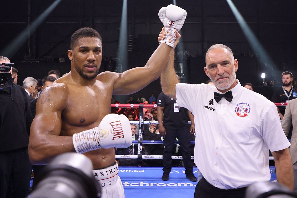 Anthony Joshua (L) of Britain celebrates after defeating Otto Wallin of Sweden (not pictured) during their heavyweight boxing match at the Kingdom Arena in Riyadh, Saudi Arabia, December 23, 2023. /CFP