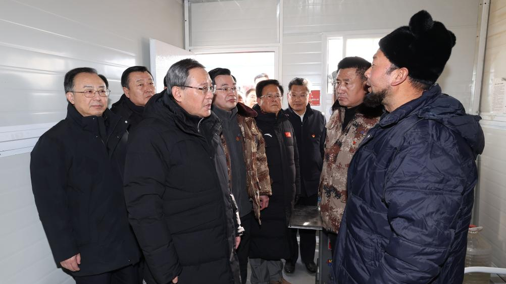 Chinese Premier Li Qiang, also a member of the Standing Committee of the Political Bureau of the CPC Central Committee, talks with people affected by an earthquake in Chenjia Village of Dahejia Township, Jishishan County, northwest China's Gansu Province, December 23, 2023. /Xinhua