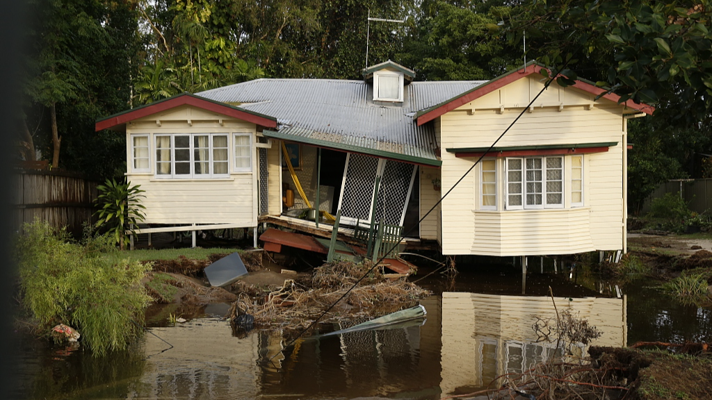 A house has partially collapsed, bringing down power lines and poles in the Cairns suburb of Holloways Beach after major flooding, Queensland, Australia, December 18, 2023. /CFP