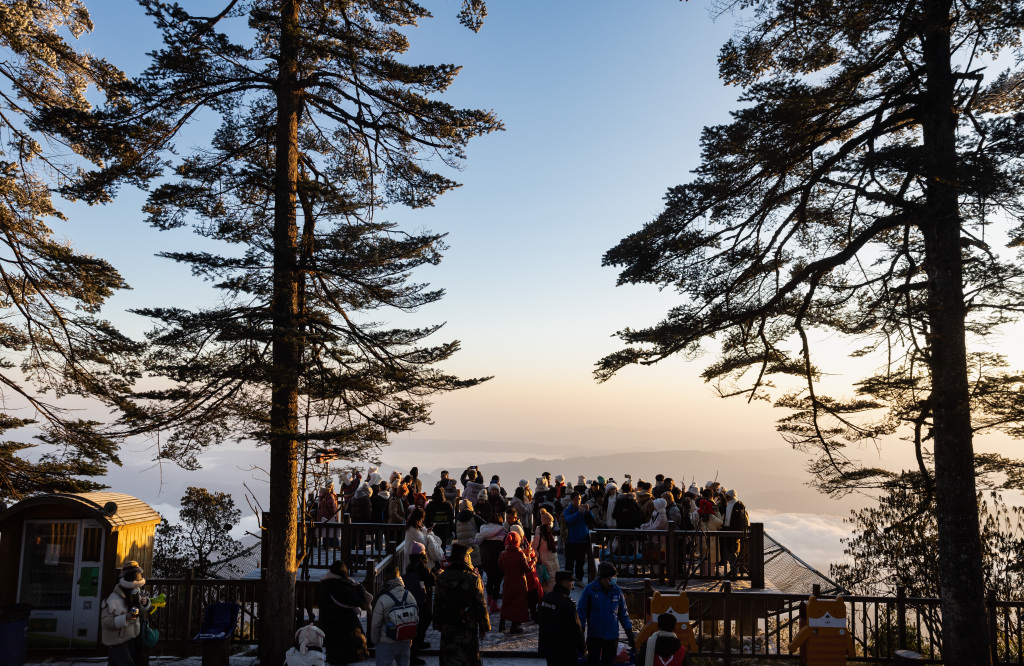Visitors enjoy the panoramic scenery from a sightseeing platform at Wawushan National Forest Park in southwest China's Sichuan Province on December 24, 2023. /CFP