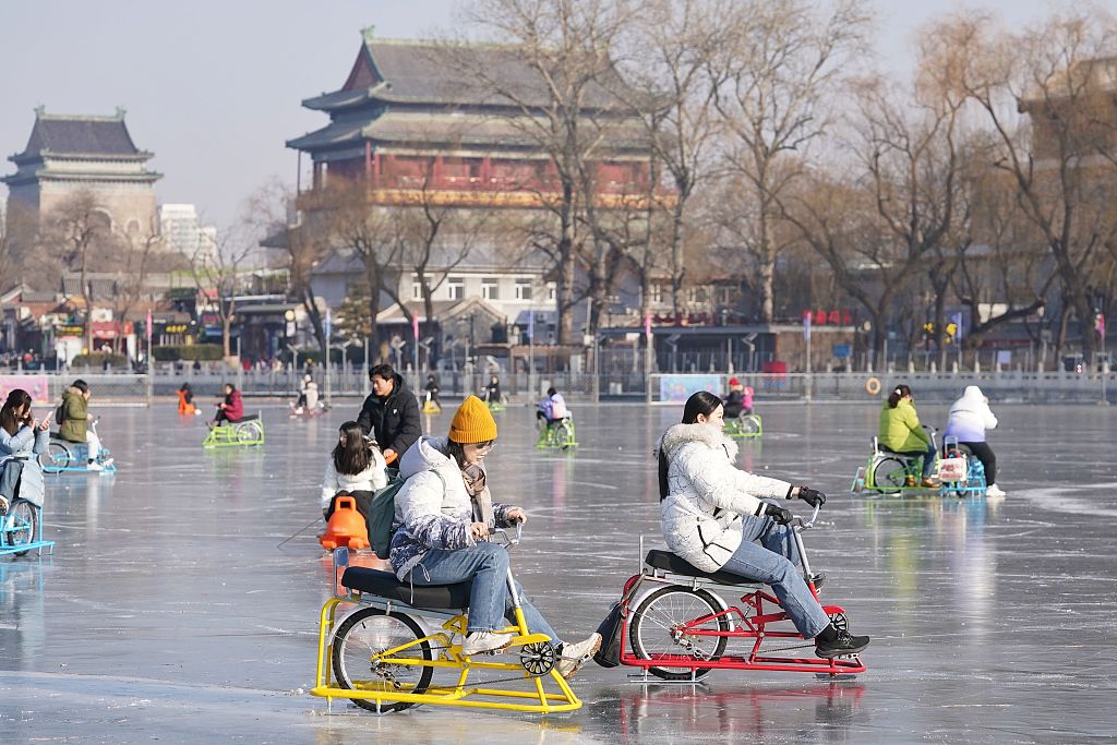 A photo taken on December 29, 2023 shows people riding ice bicycles at the Shichahai Ice Rink in Beijing, China. /CFP