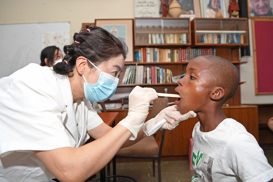 A member of a Chinese medical team examines a child at the SOS Children's Village in Windhoek, Namibia, December 11, 2023. /Xinhua