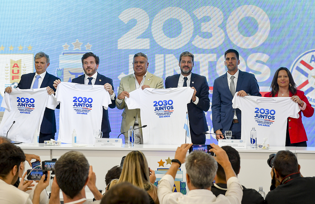 Sports secretaries of Uruguay, Argentina, Paraguay and Chile (L-R) pose with T-shirts that read in Spanish 