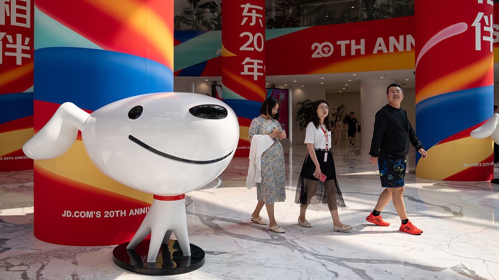 Attendees walk inside the JD.com Inc. headquarters during a ceremony marking the company's 20th anniversary, Beijing, China, June 18, 2023. /CFP