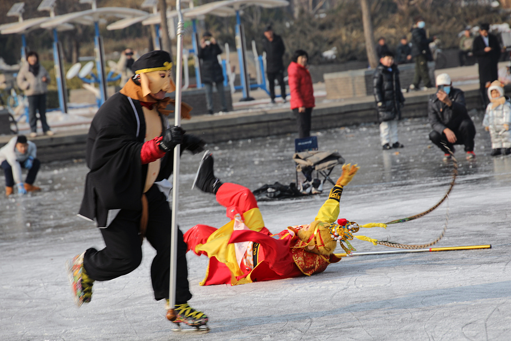 The Monkey King, portrayed by a local resident, is spotted losing his footing on the Haihe River's ice surface in north China's Tianjin Municipality on December 29, 2023. /CFP