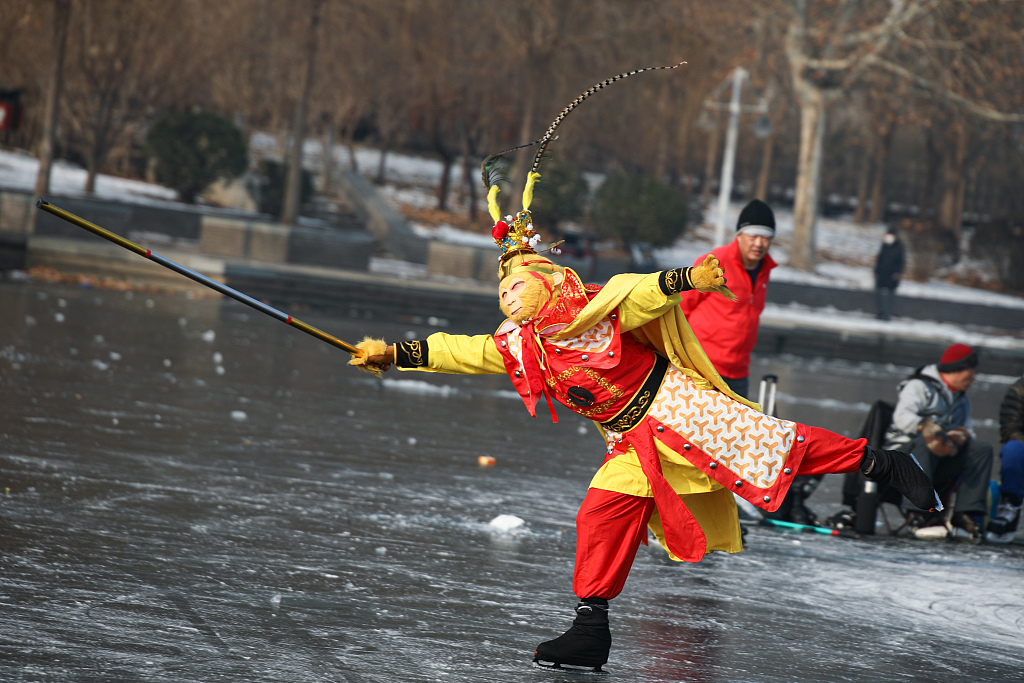 The Monkey King, portrayed by a local resident, happily glides on the Haihe River's ice surface in north China's Tianjin Municipality on December 29, 2023. /CFP