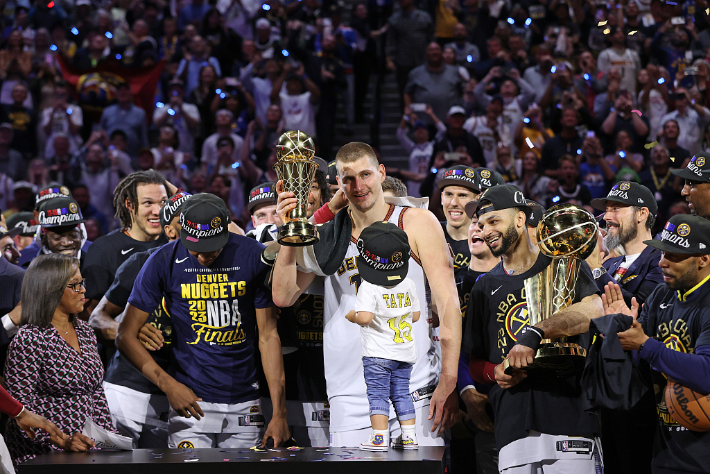 Nikola Jokic (C) of the Denver Nuggets celebrate with the Larry O'Brien Championship Trophy and the Bill Russell NBA Finals Most Valuable Player Trophy after defeating the Miami Heat 94-89 in Game 5 of the series at Ball Arena in Denver, Colorado, June 13, 2023. /CFP
