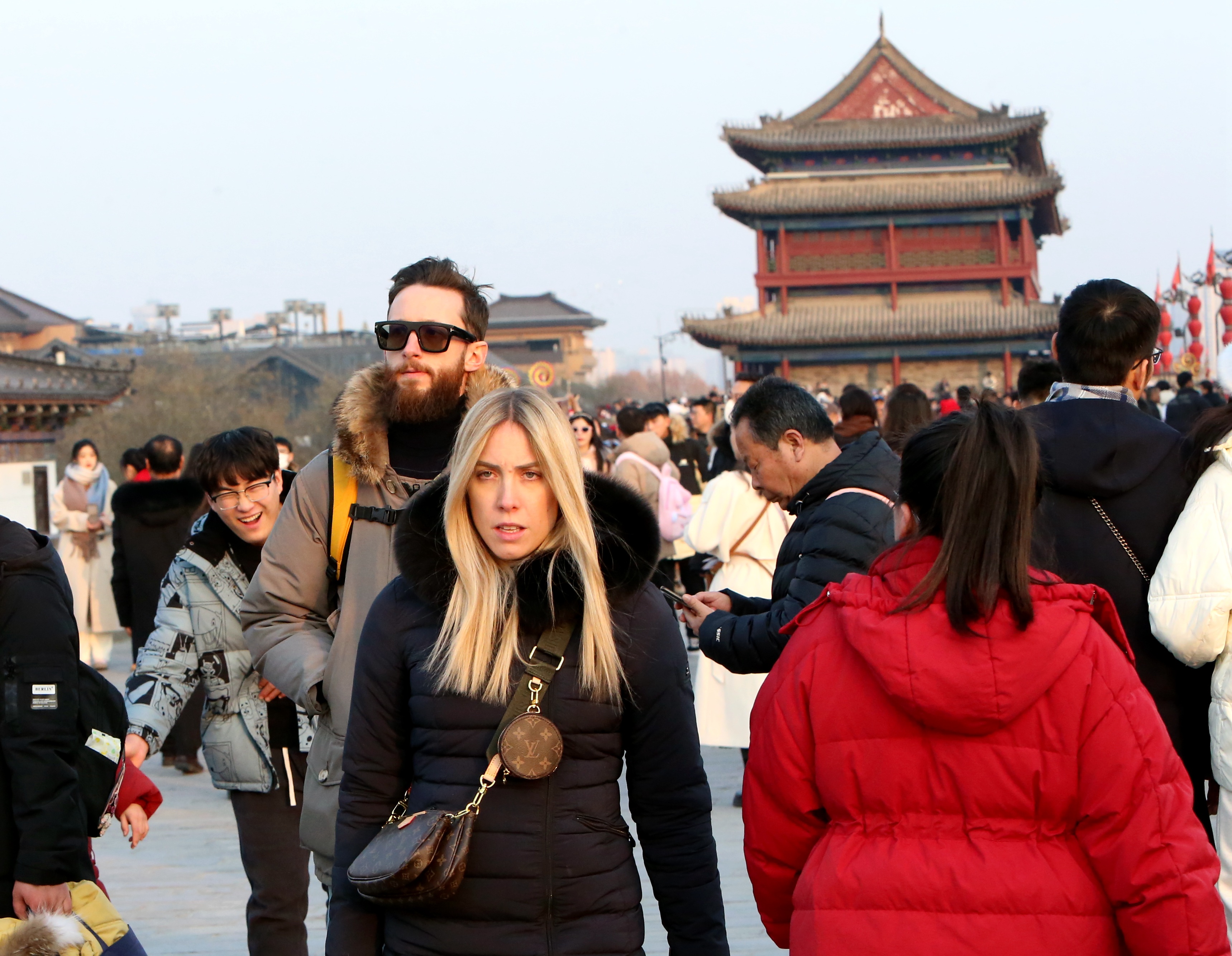 Tourists stroll along the ancient city wall of Xi'an in northwest China's Shaanxi Province on December 23, 2023. /IC