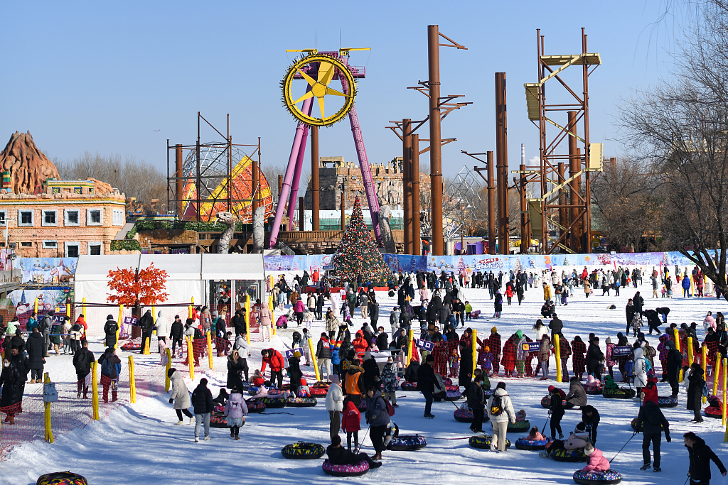 People enjoy winter sports at the Happy Valley theme park in Beijing on December 31, 2023. /CFP