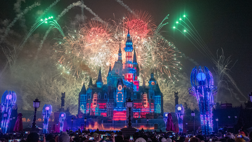 People take pictures of a night show at Shanghai Disneyland in Shanghai, east China, January 1, 2024. /CFP