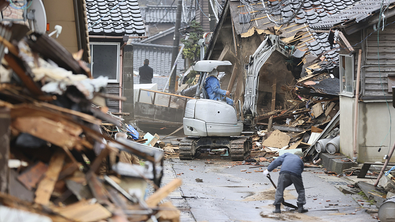 A worker removes debris at a collapsed house in Wajima City, Ishikawa Prefecture, Japan, January 3, 2024. /CFP