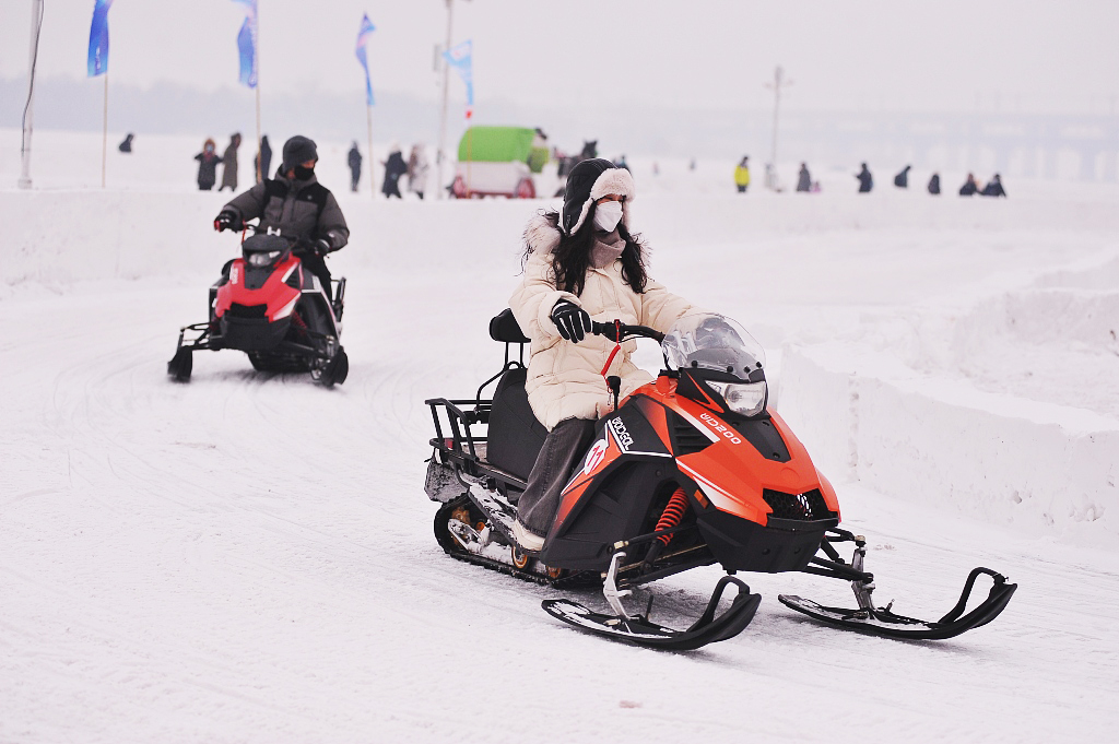 Visitors experience winter sports on the frozen surface of the Songhua River in Harbin, Heilongjiang Province on December 30, 2023. /CFP