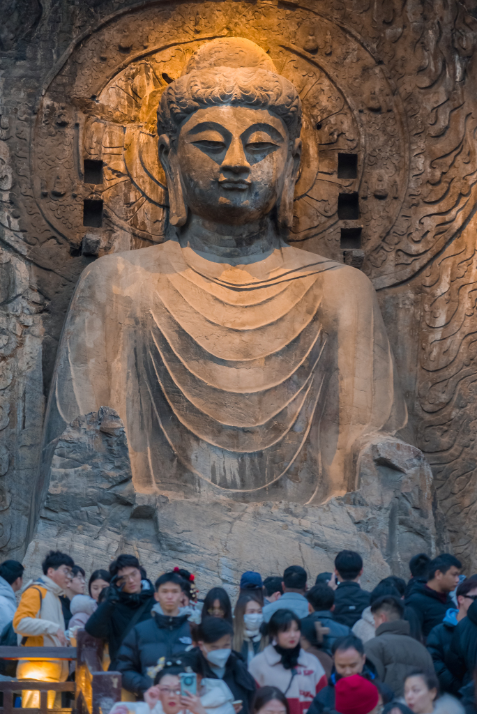 The Lushena Buddha glows amid soft lighting at the Longmen Grottoes in Luoyang, Henan Province on December 31, 2023. /CFP